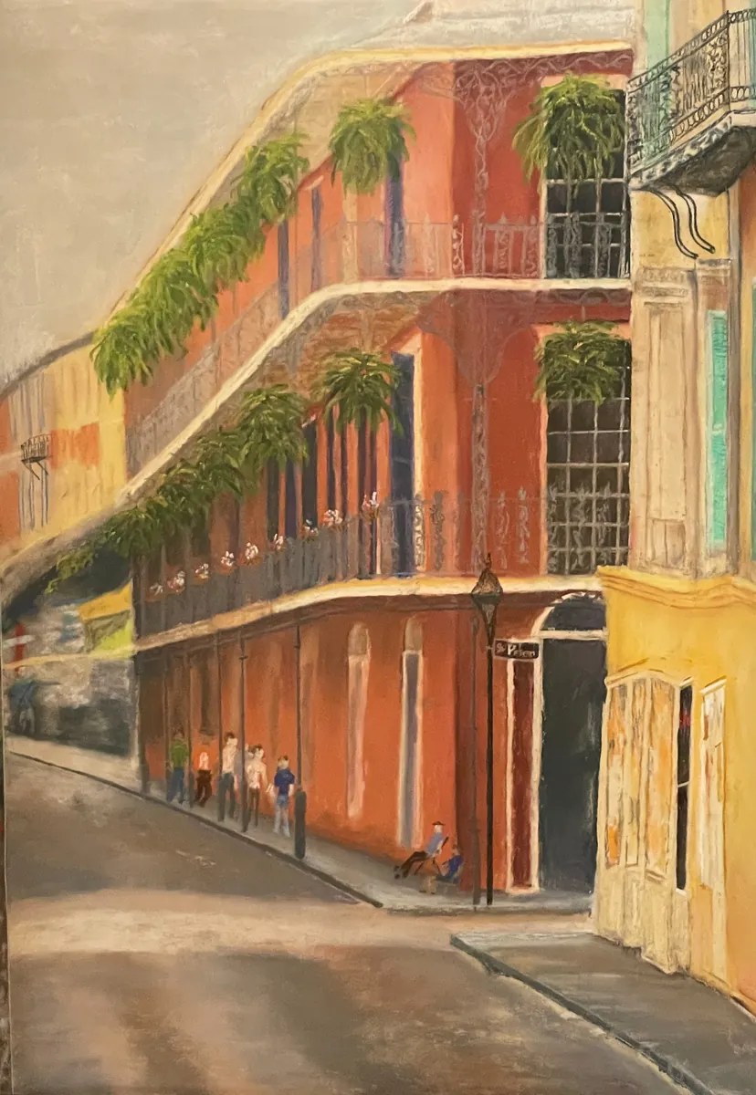 Sunlit coral corner building with iron balconies and trailing greenery on a narrow street