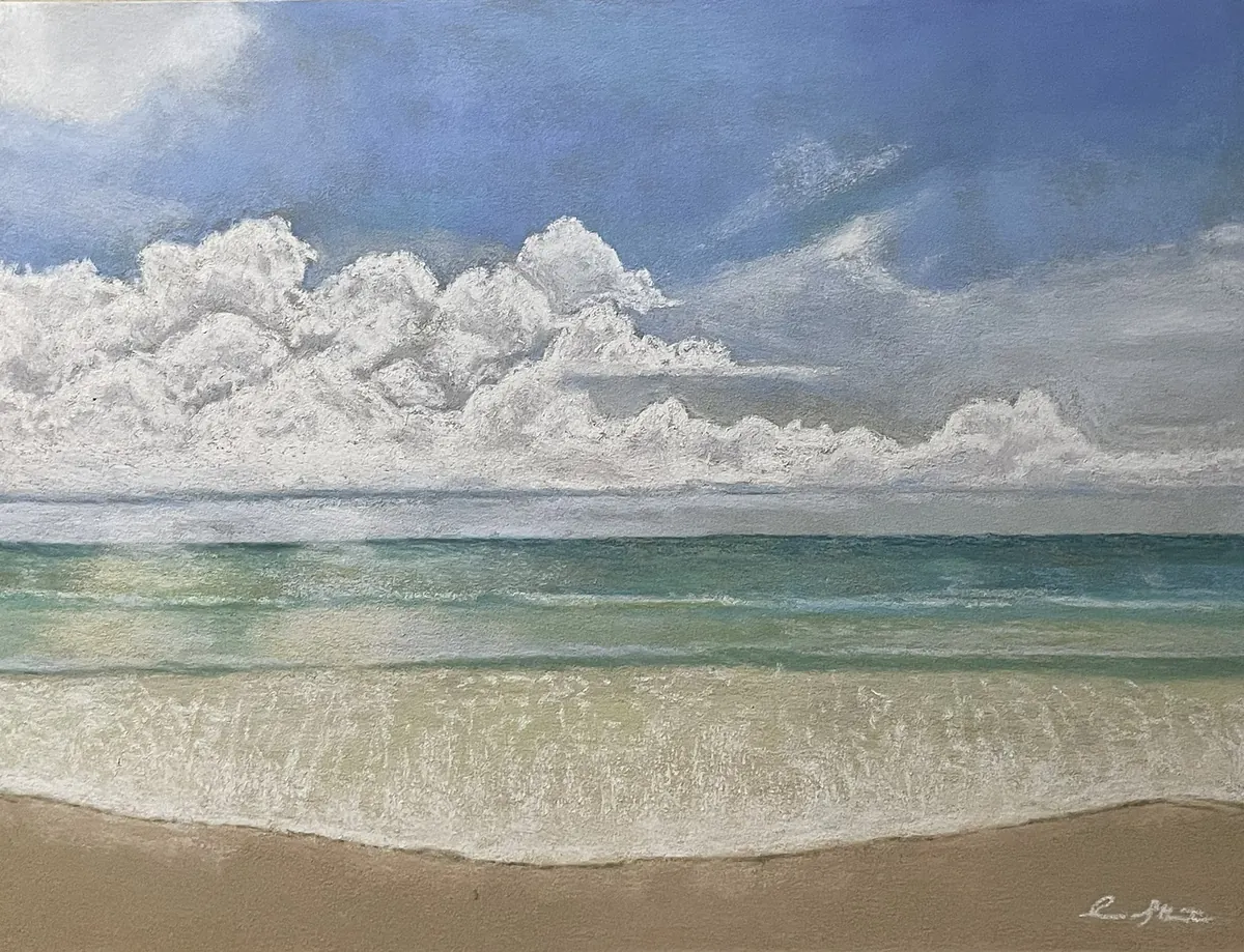 Bright white cloud bank over turquoise Gulf Coast water and a quiet sandy shore