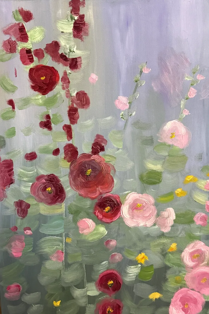 Loose pink and deep red hollyhocks rising against a pale gray-green ground