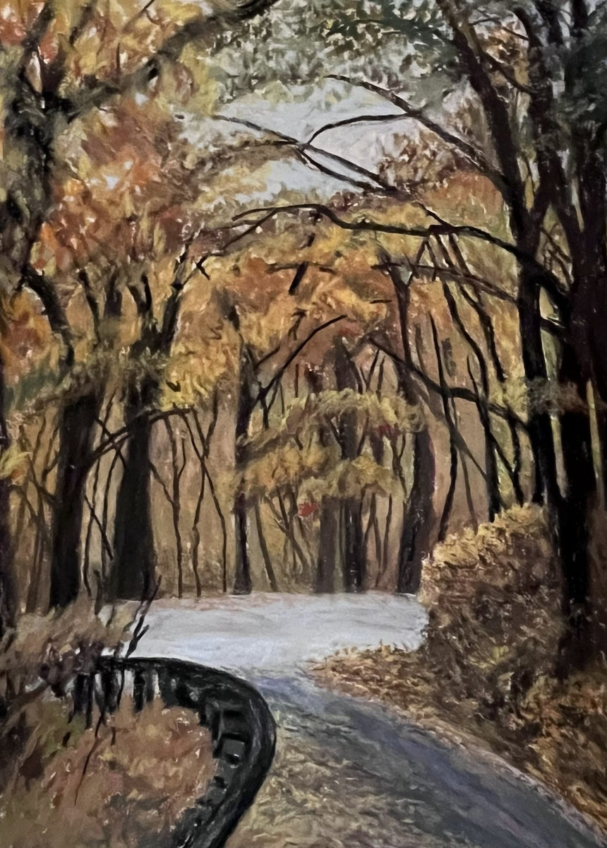 A winding Blue Ridge Parkway road with a dark guardrail beneath arching gold and russet autumn trees