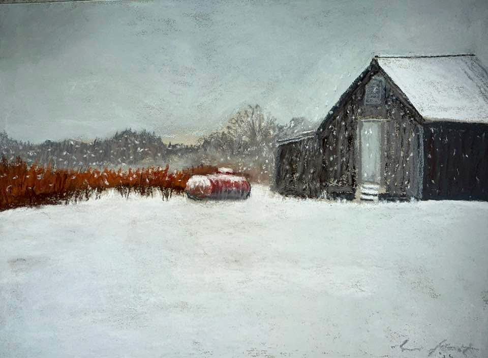 Snow falling around an old dark barn and a red farm tank beside a rust-colored field
