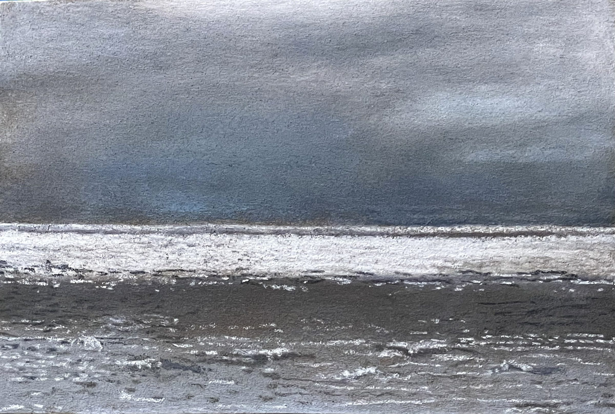 Dark storm clouds above bands of pale surf and a charcoal ocean